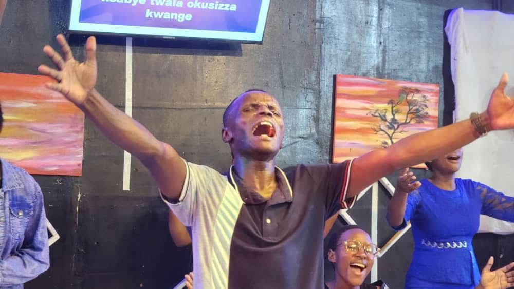 Worshippers lifting their hands during EPIC Church service