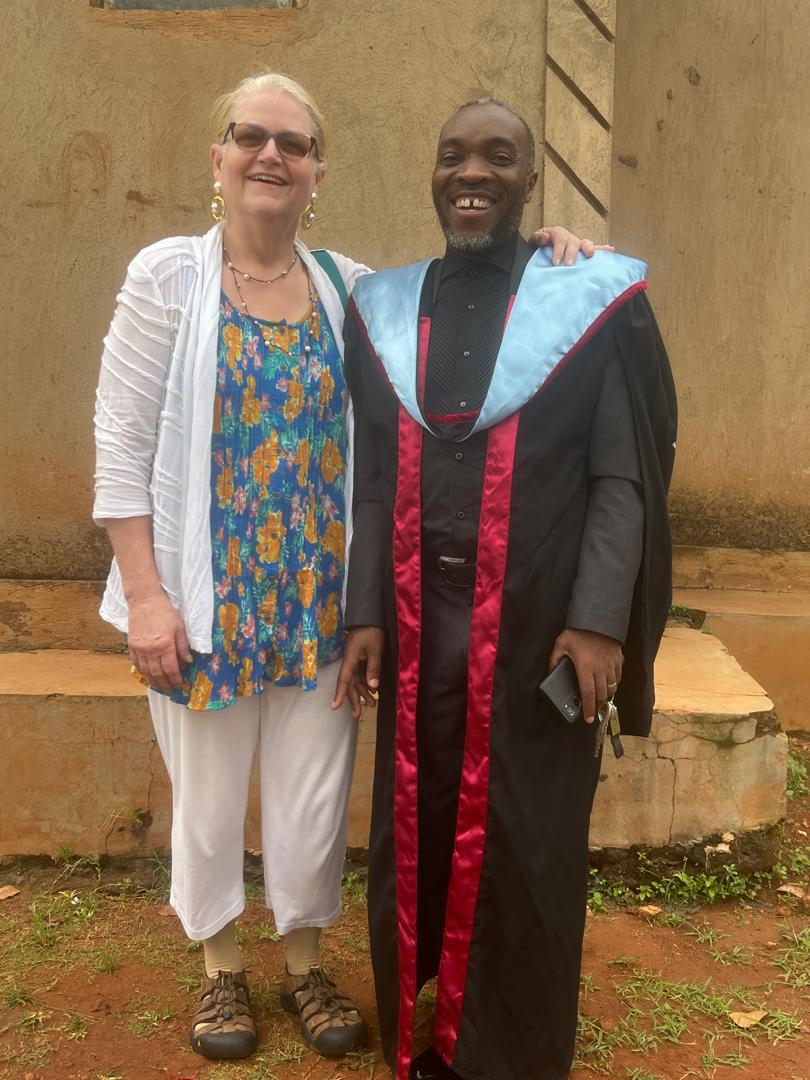 Graduate and supporter smiling together after a ceremony